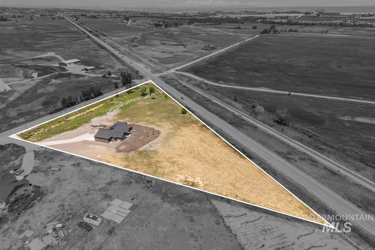 Aerial view of sparsely populated area featuring property boundaries highlighted