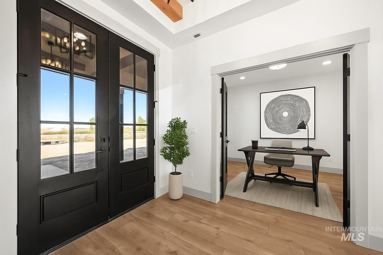 Entryway with light wood-style flooring and french doors