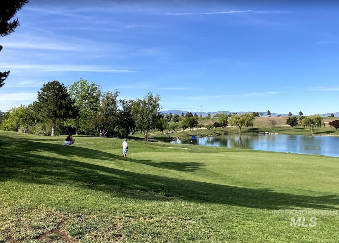 View of home's community with a water and mountain view and golf course view