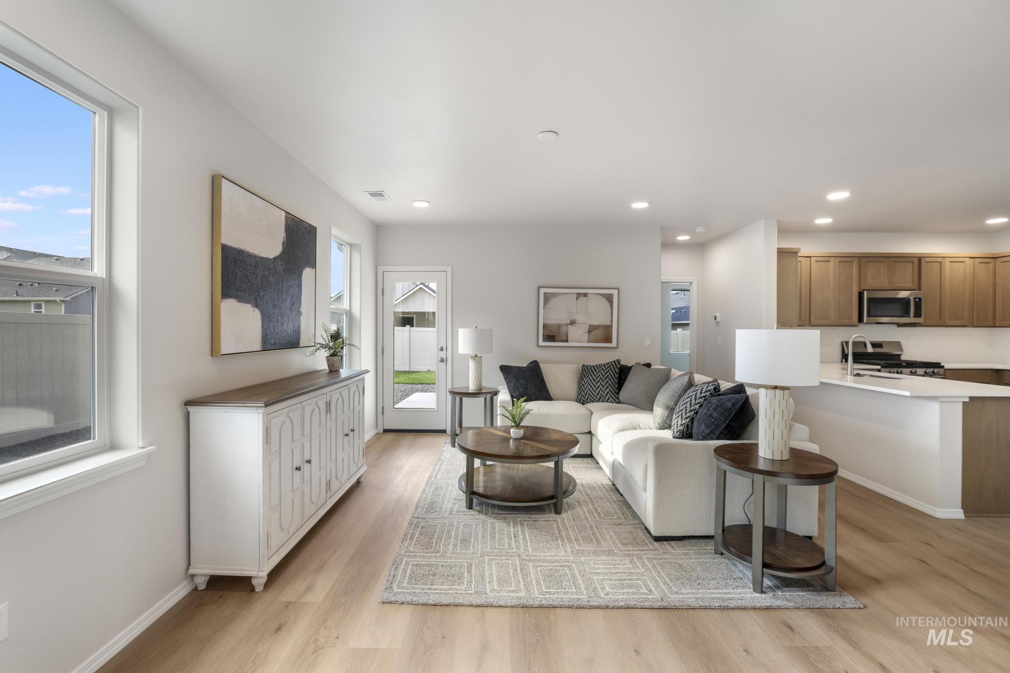 Living room featuring light wood-style floors and recessed lighting