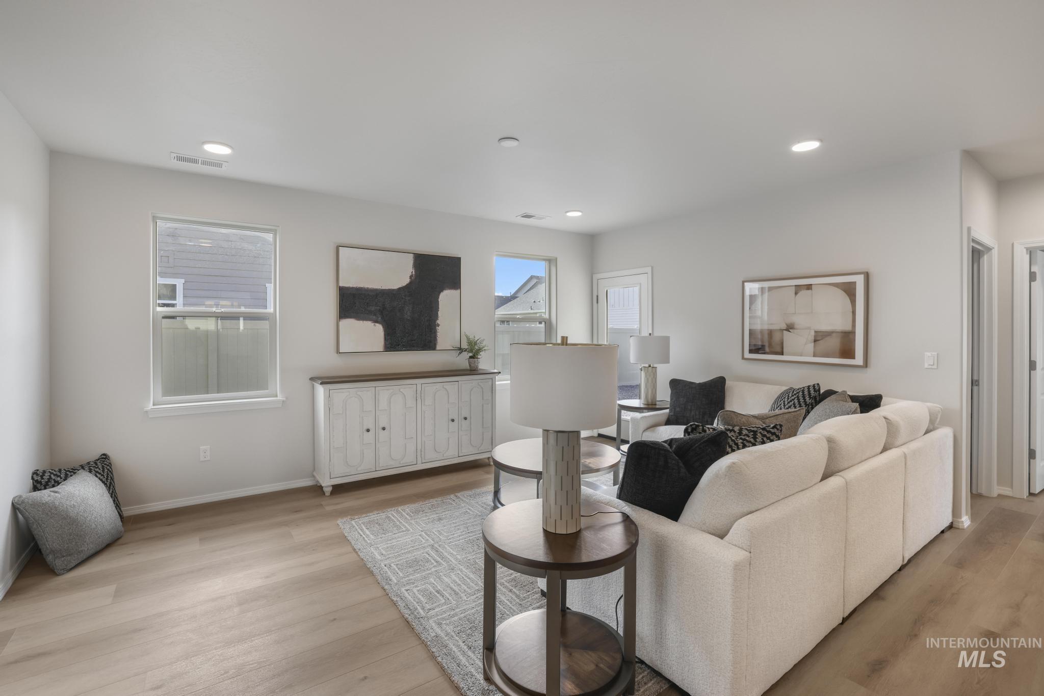 Living area featuring light wood-style floors and recessed lighting