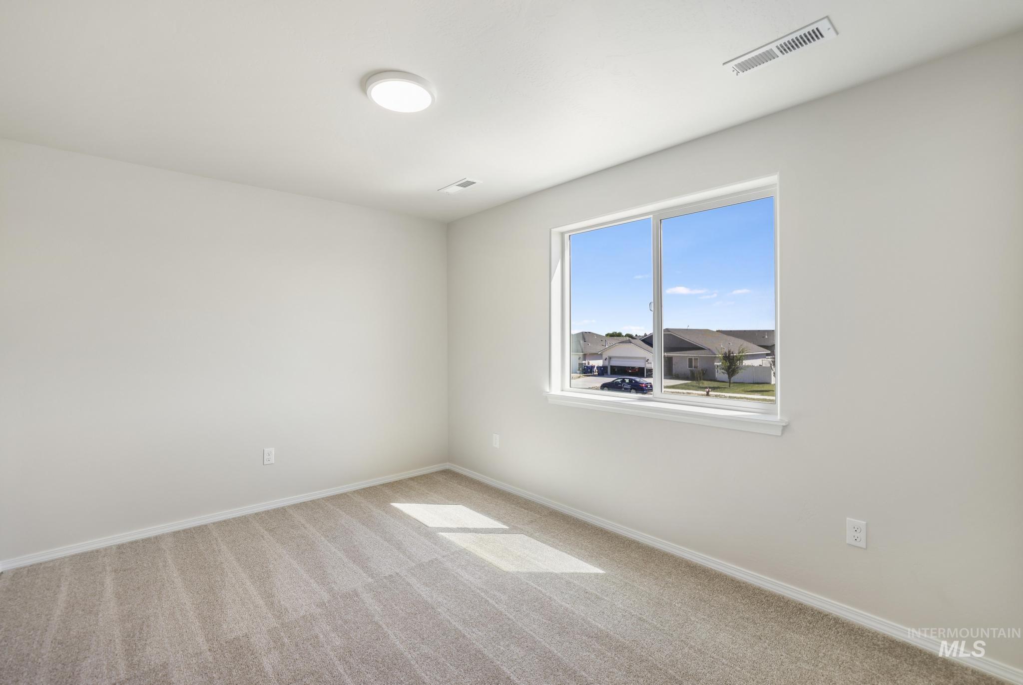 Unfurnished room featuring carpet and baseboards