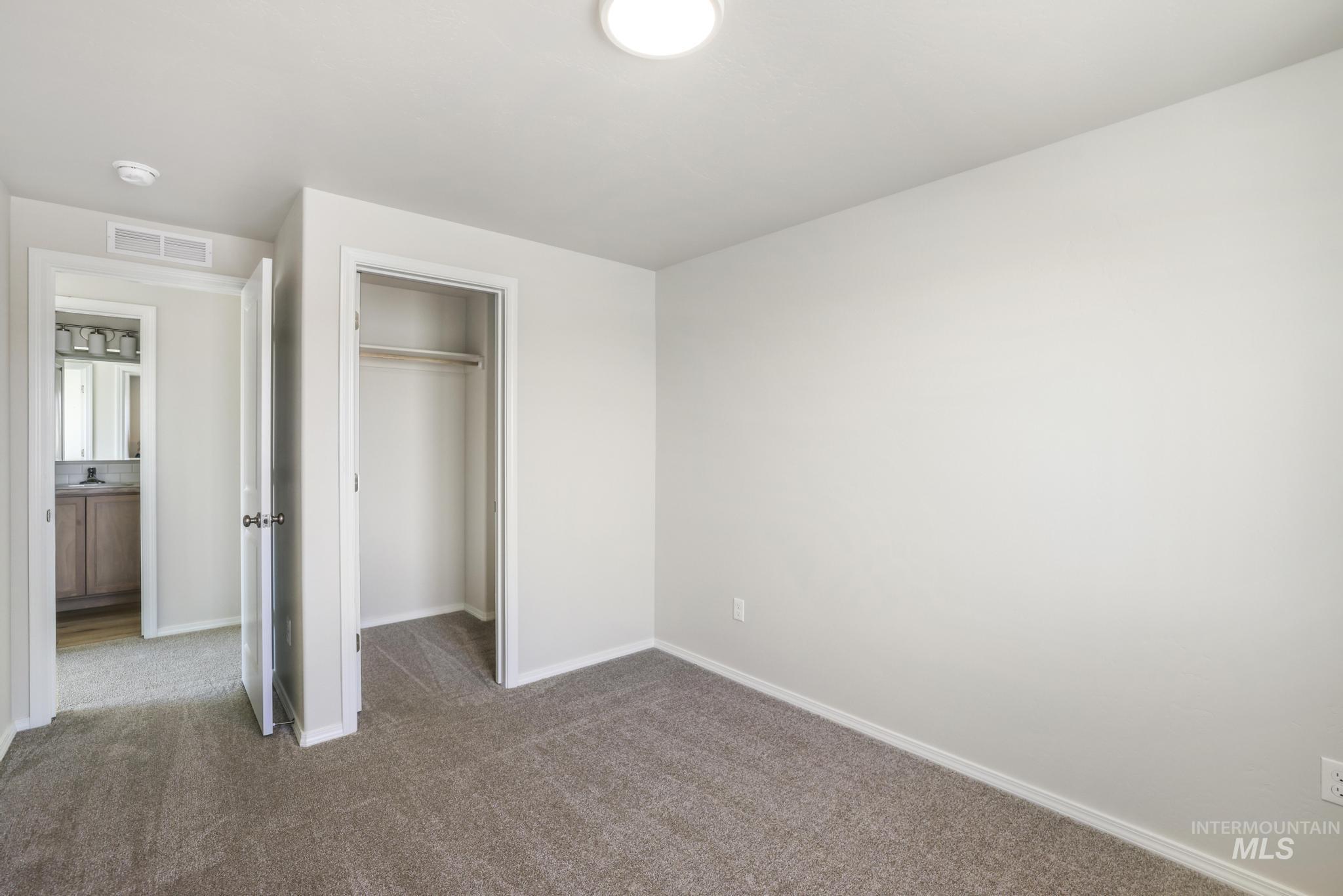 Unfurnished bedroom with carpet and a closet