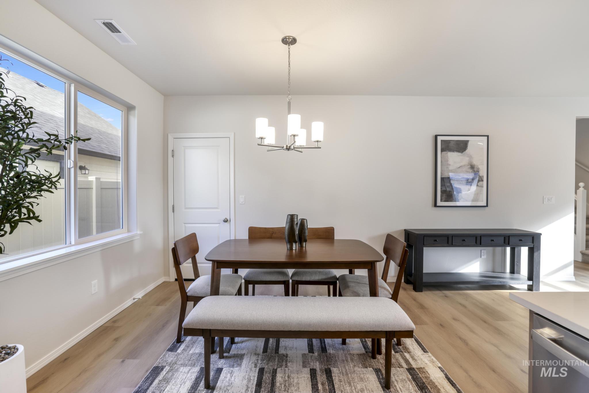 Dining room with a chandelier and light wood-style floors