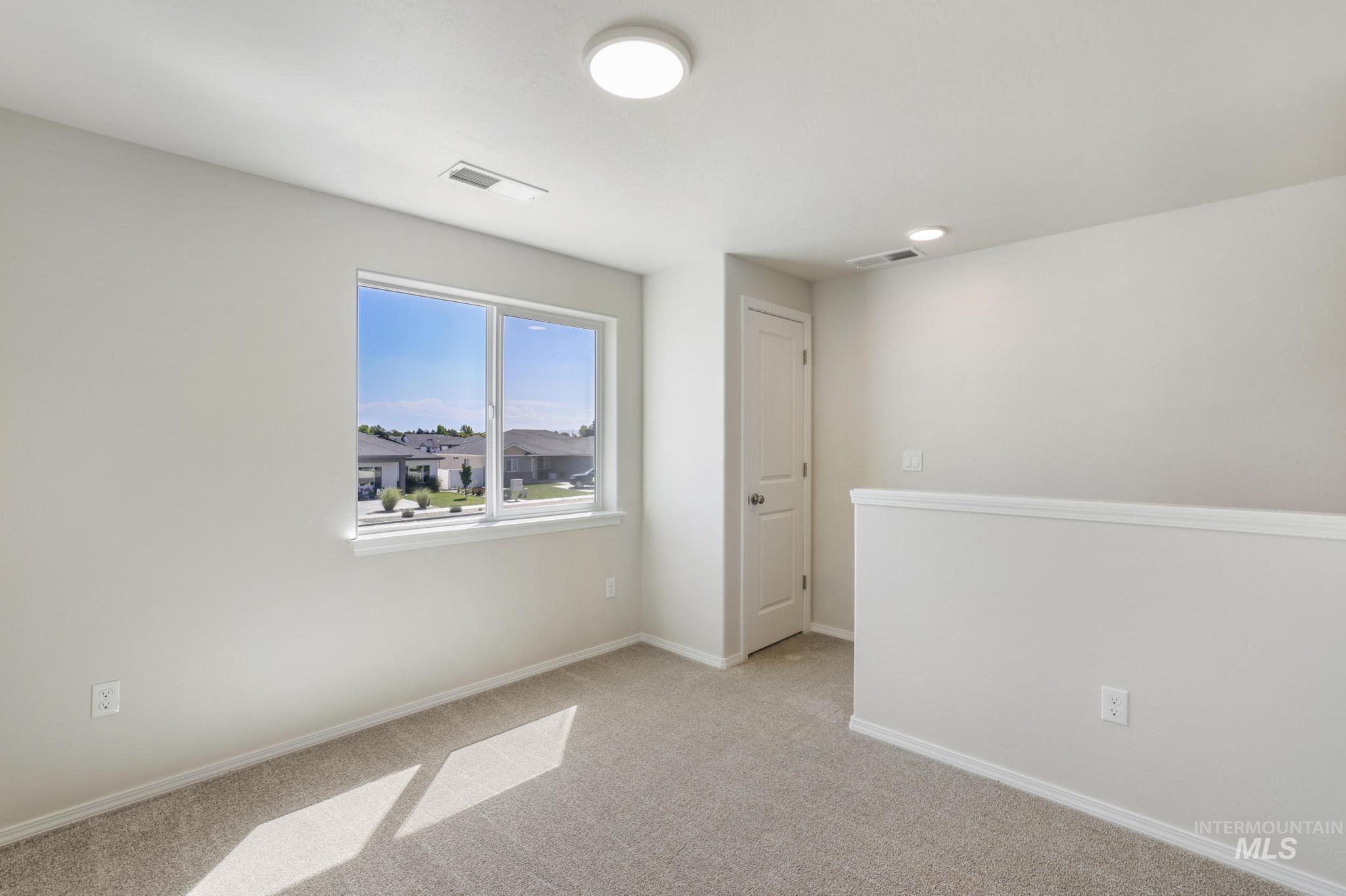 Empty room with carpet and baseboards