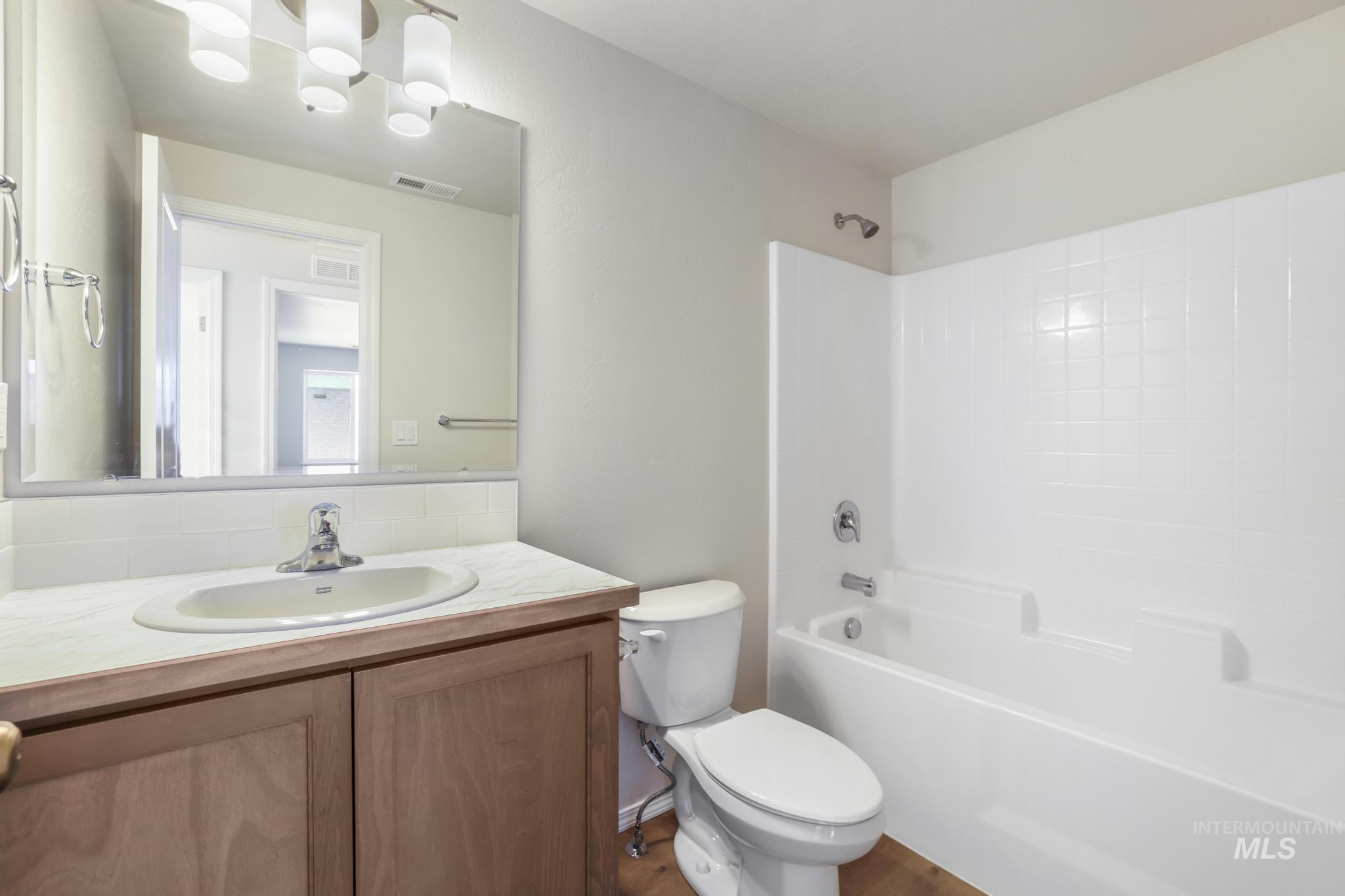 Bathroom featuring washtub / shower combination and vanity