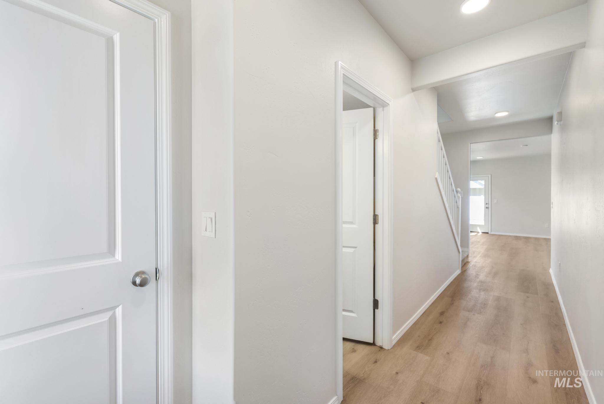 Hall featuring light wood-type flooring and recessed lighting