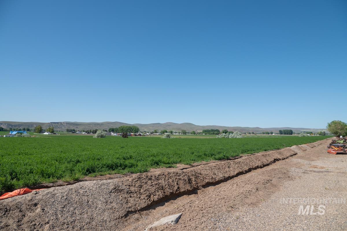 View of mountain backdrop with rural landscape and rows of crops