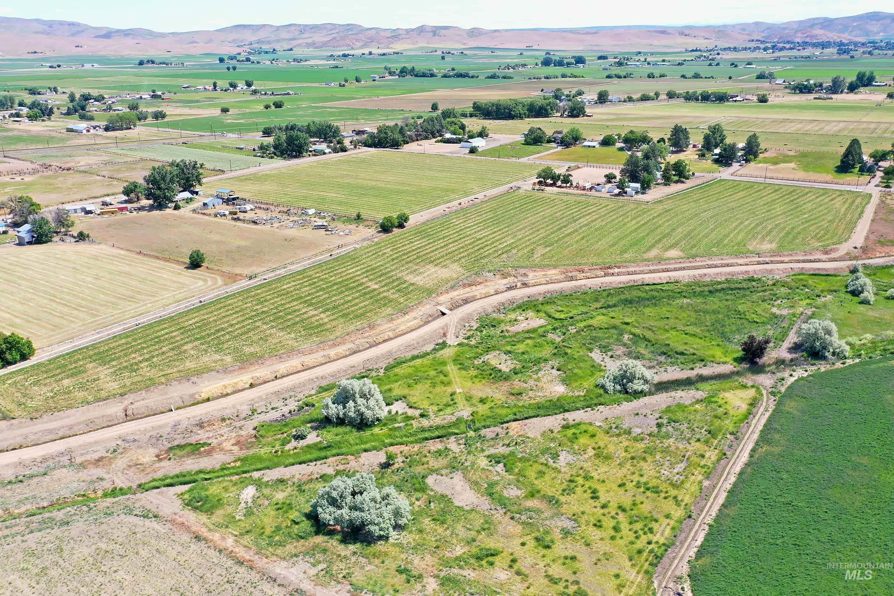 Expansive rural acreage featuring varied terrain, agricultural fields, and natural vegetation