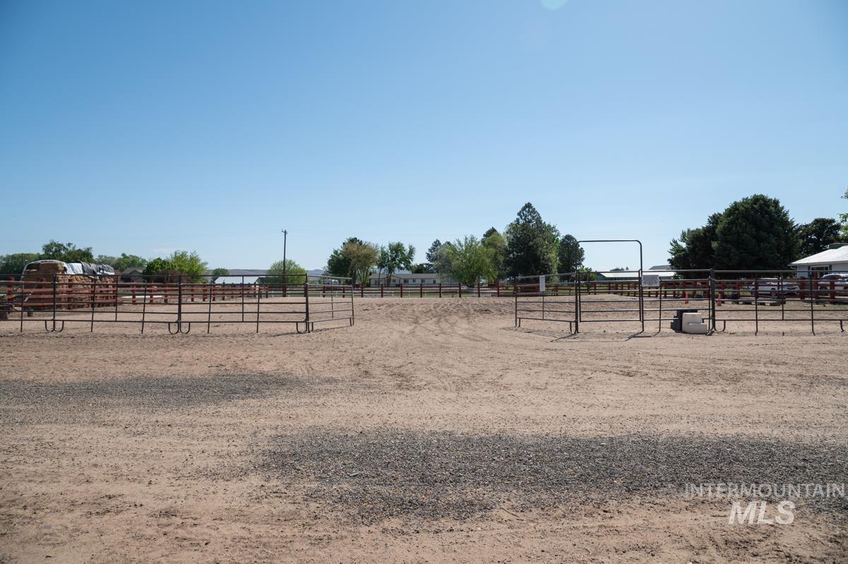 View of yard with a view of countryside and an outdoor riding arena
