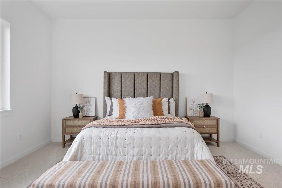 Bedroom with light carpet and baseboards