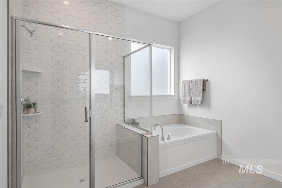 Bathroom featuring a garden tub and a stall shower