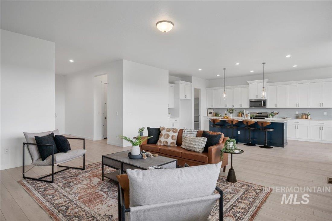 Living area featuring recessed lighting and light wood-type flooring