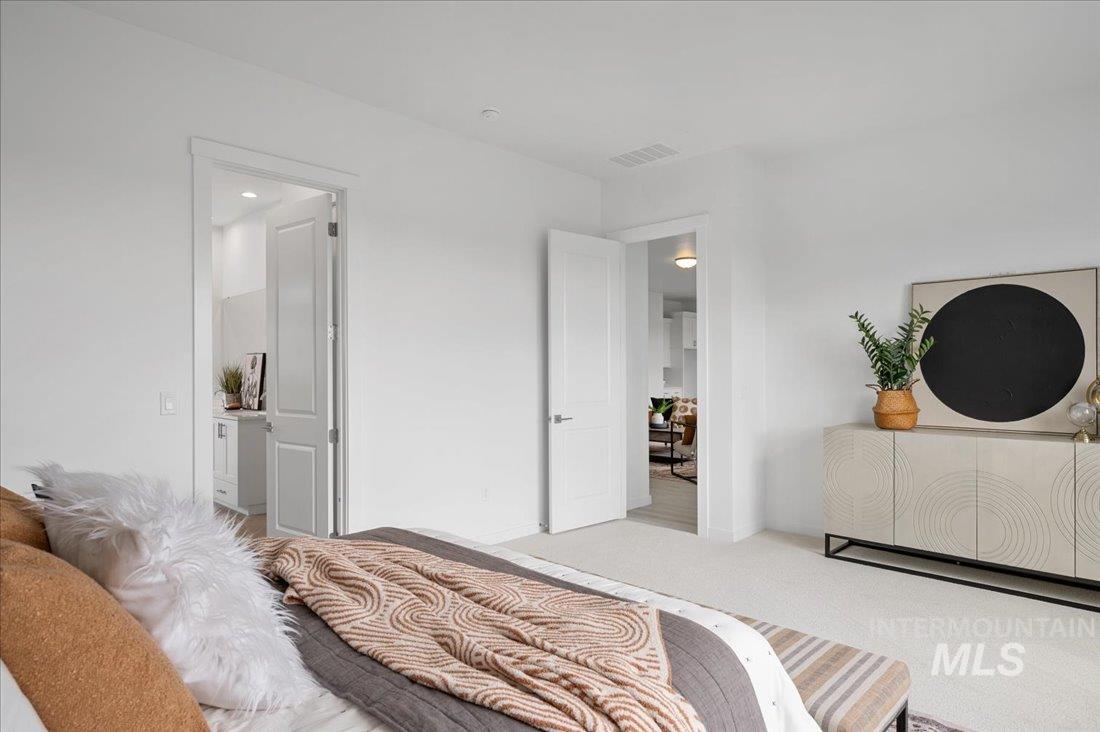 Carpeted bedroom with ensuite bath