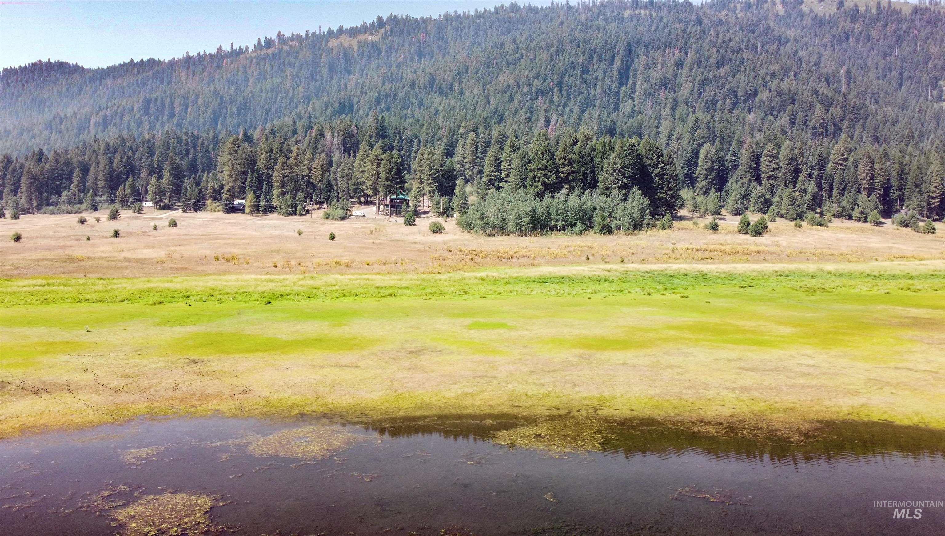 Mountain view featuring a nearby body of water and a local golf course
