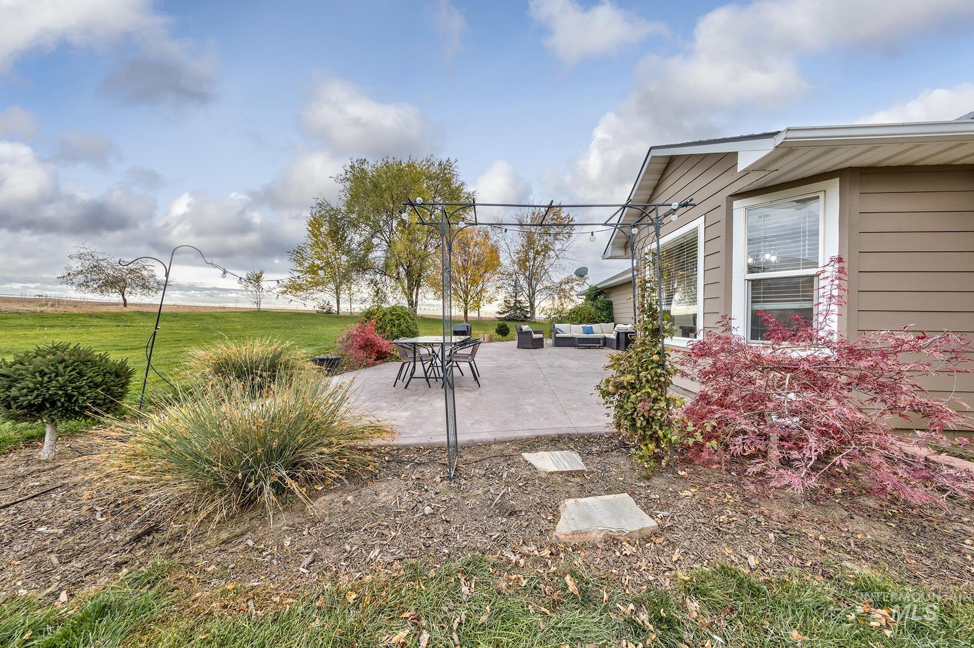 View of green lawn featuring a patio area