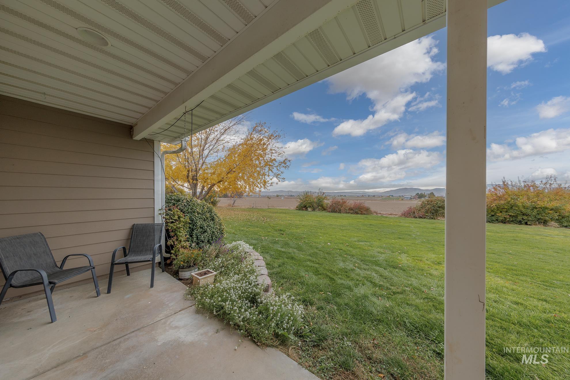 View of yard with a patio and a mountain view