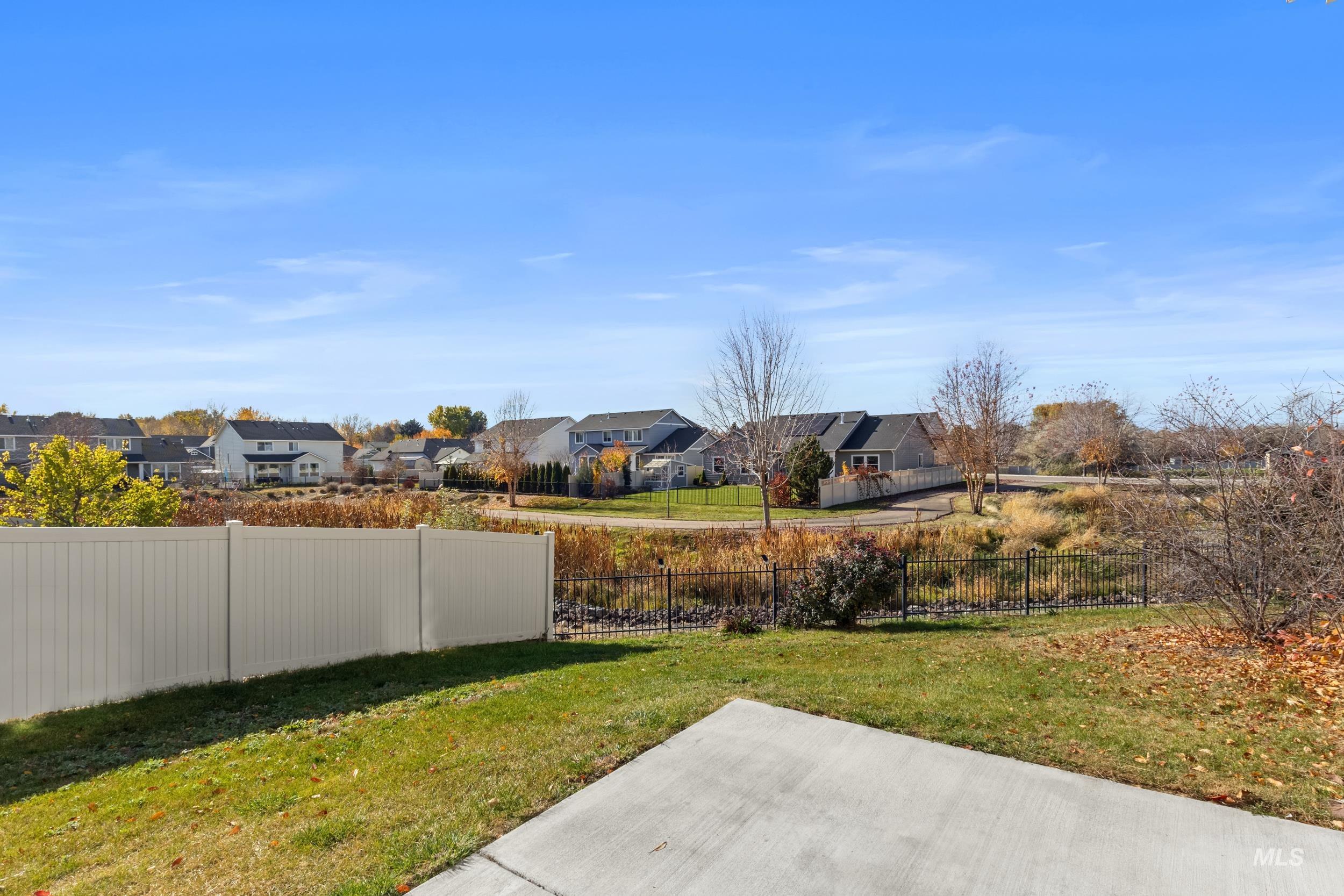 Fenced backyard featuring a residential view
