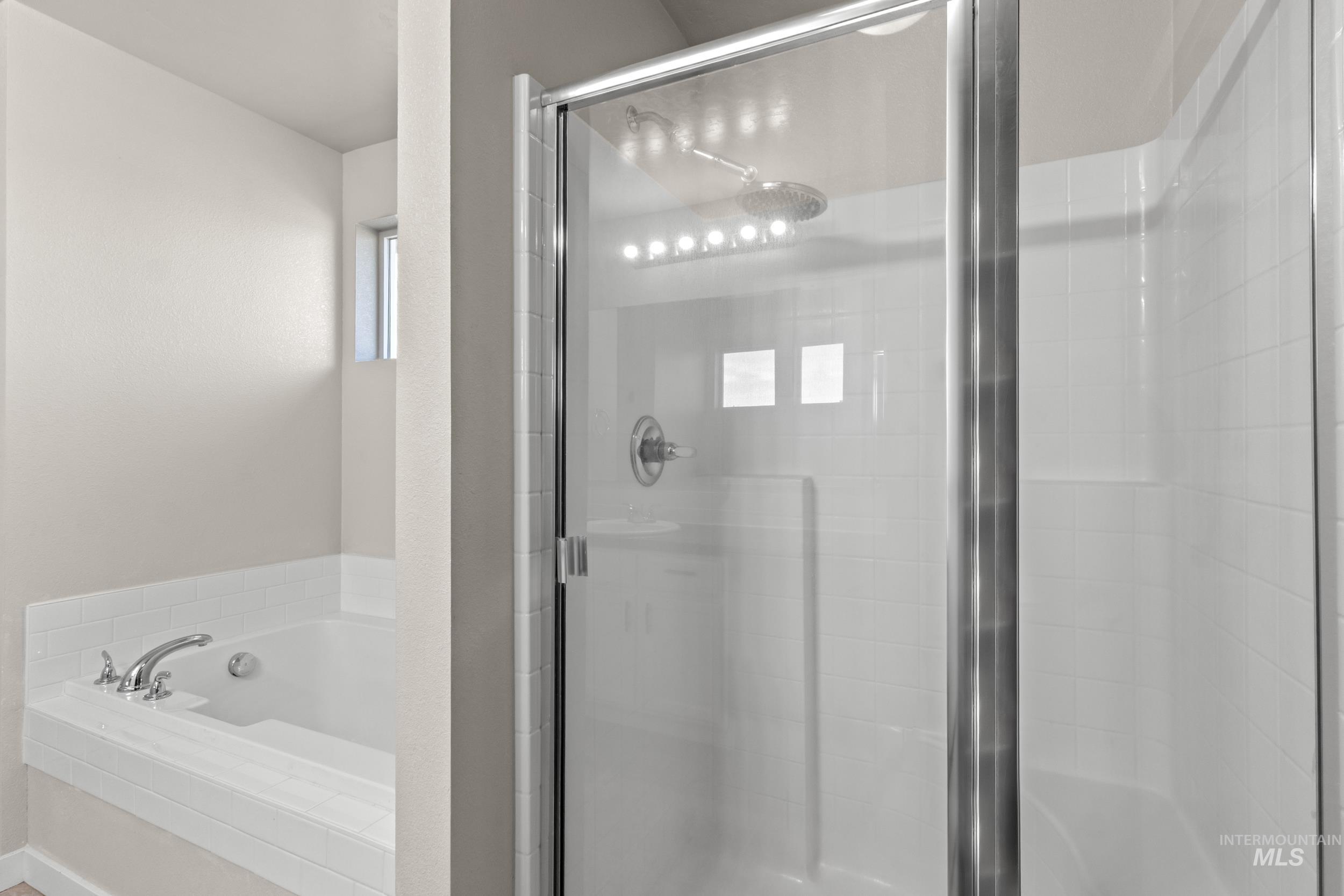 Full bath with a bath and a shower stall