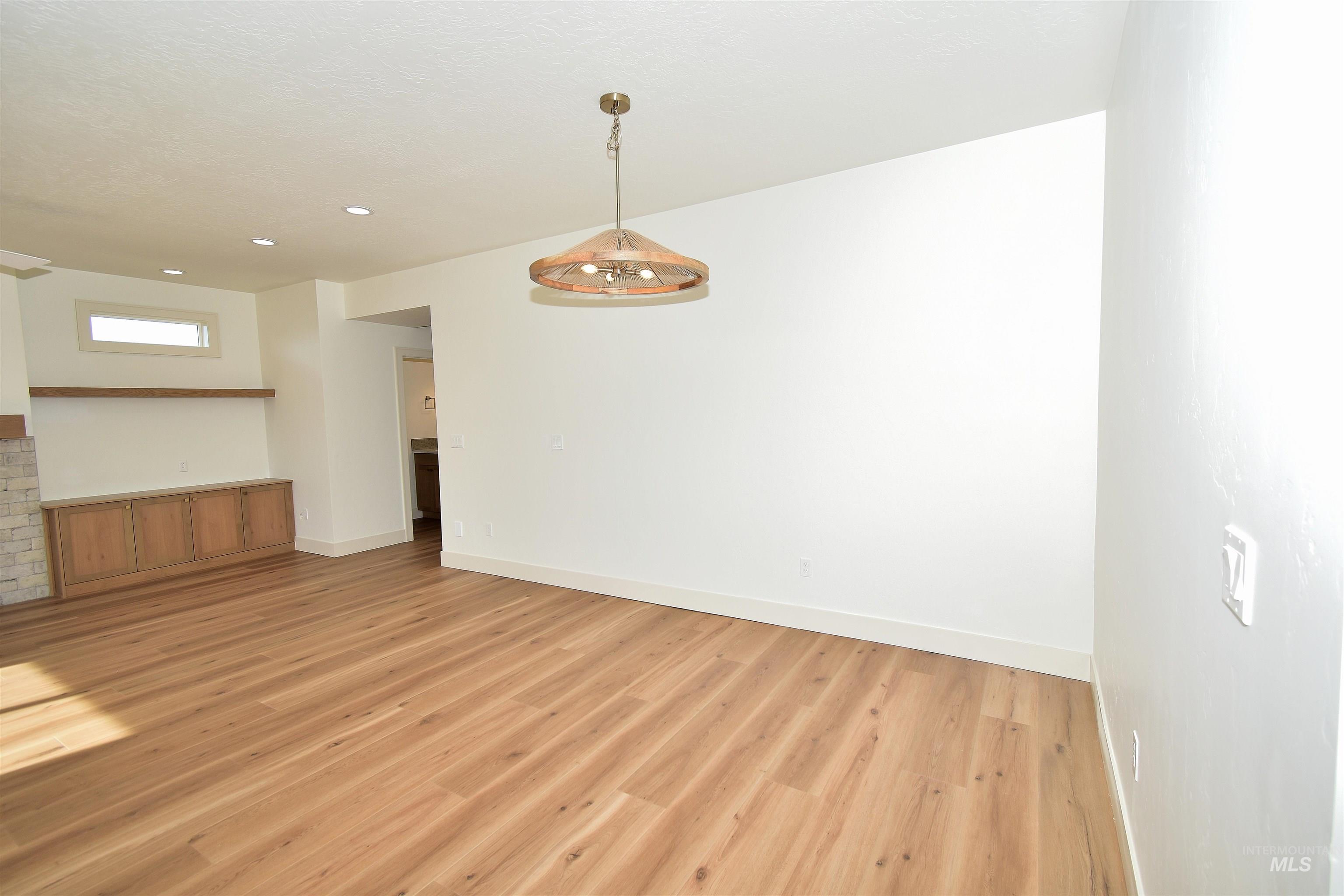 Unfurnished room with light wood finished floors and recessed lighting