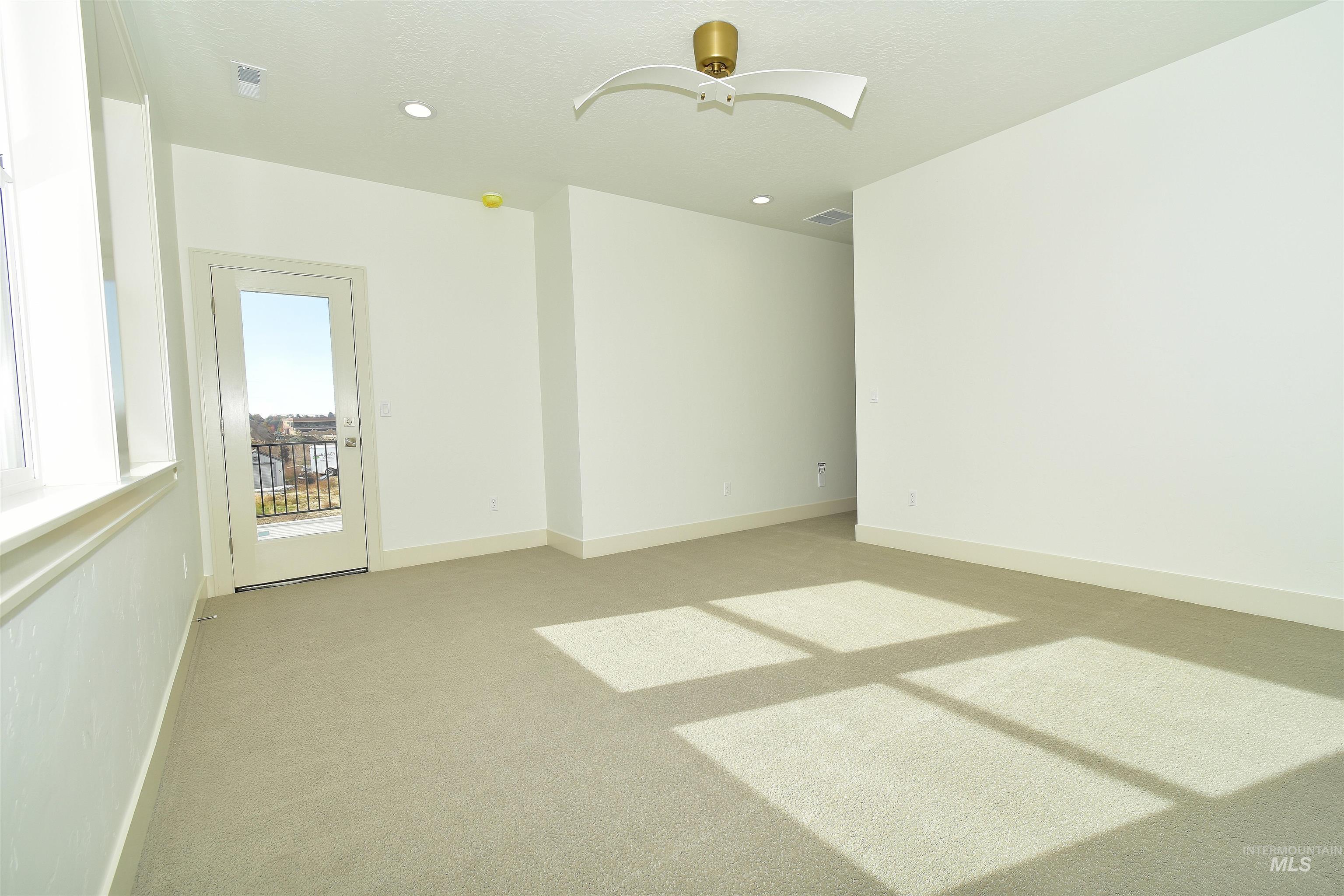 Empty room featuring light carpet, recessed lighting, and ceiling fan