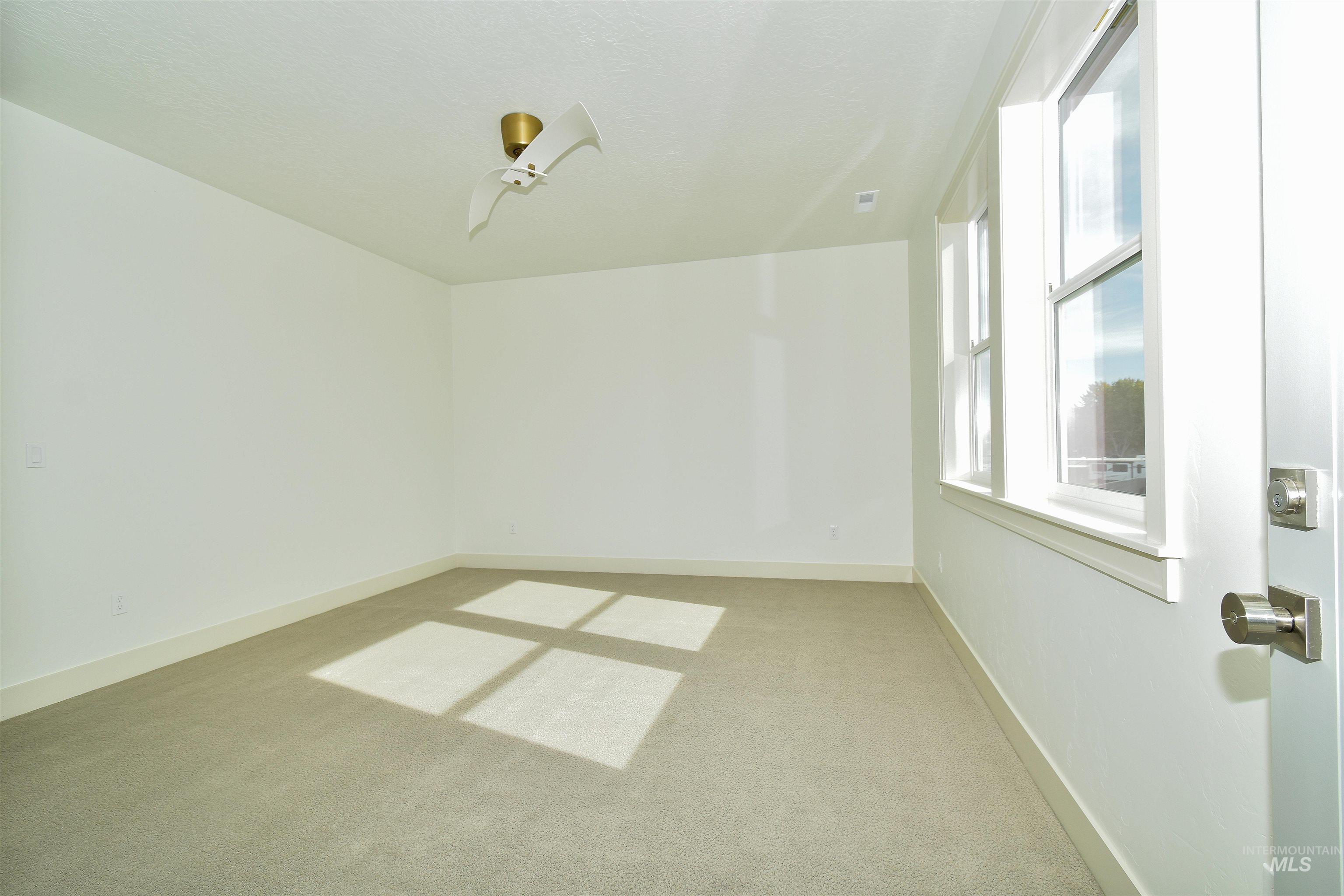 Unfurnished room with light carpet and baseboards