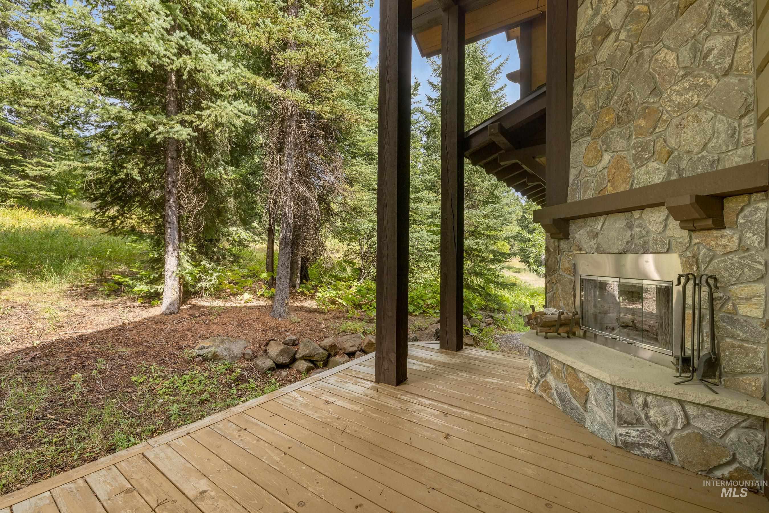 Deck featuring an outdoor stone fireplace