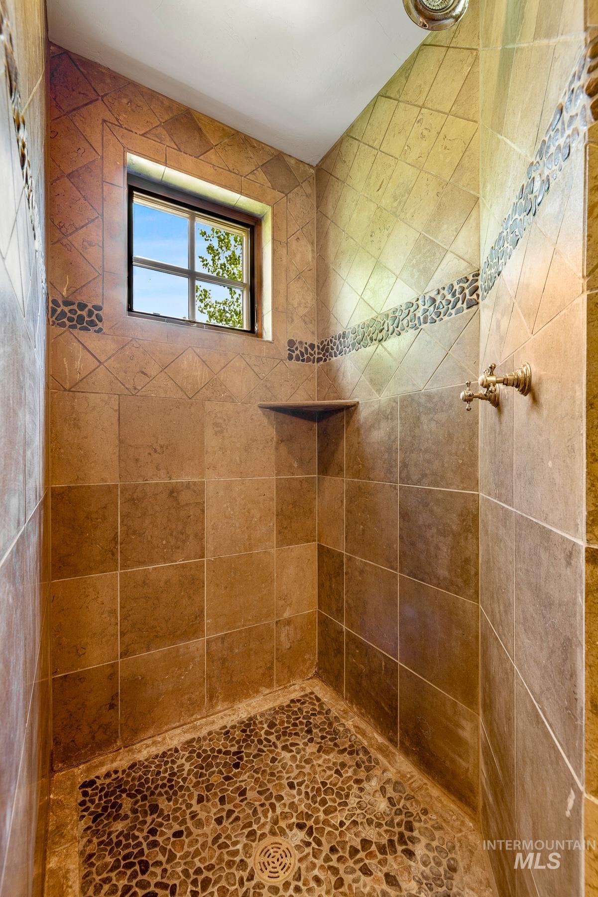 Bathroom featuring a tile shower