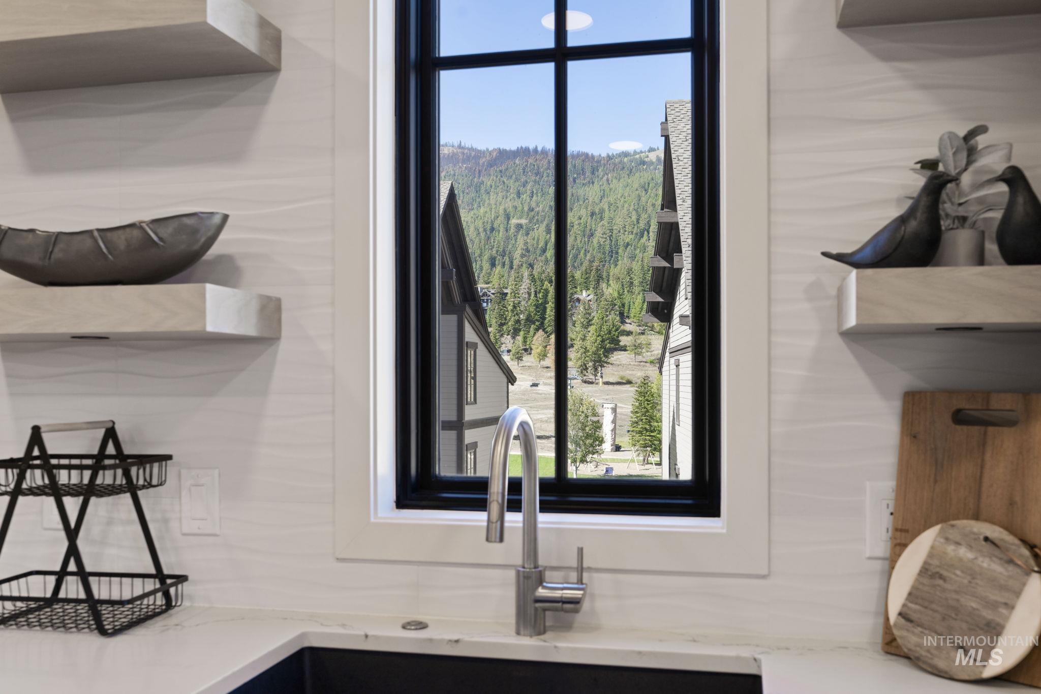 Kitchen view of light stone countertops and open shelves