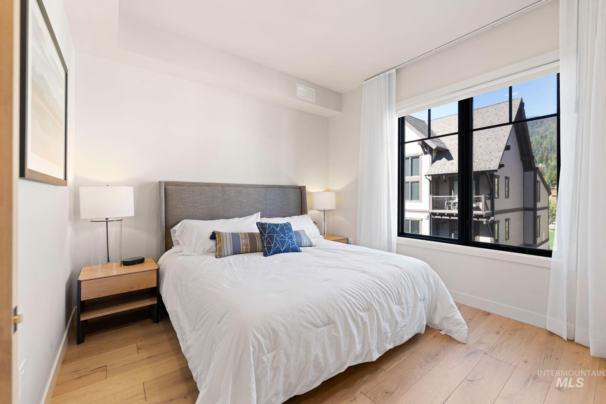 Bedroom featuring light wood-style floors and baseboards