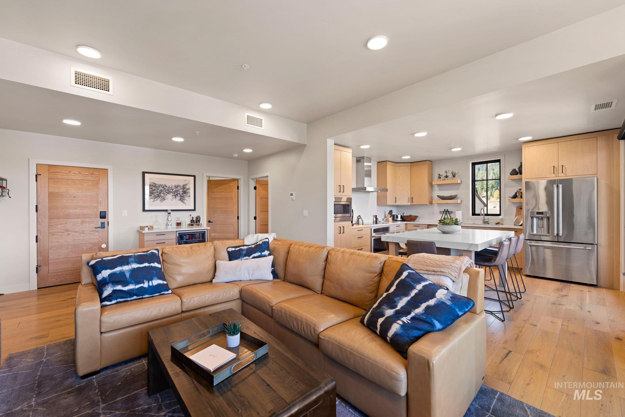 Living room with light wood-style floors and recessed lighting
