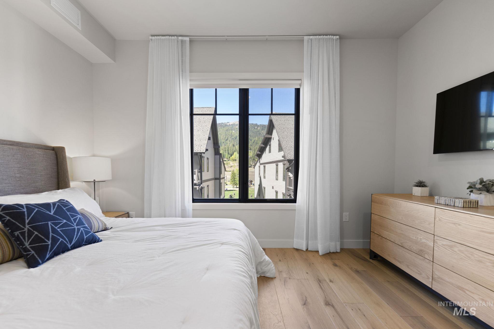 Bedroom with light wood-style floors and baseboards
