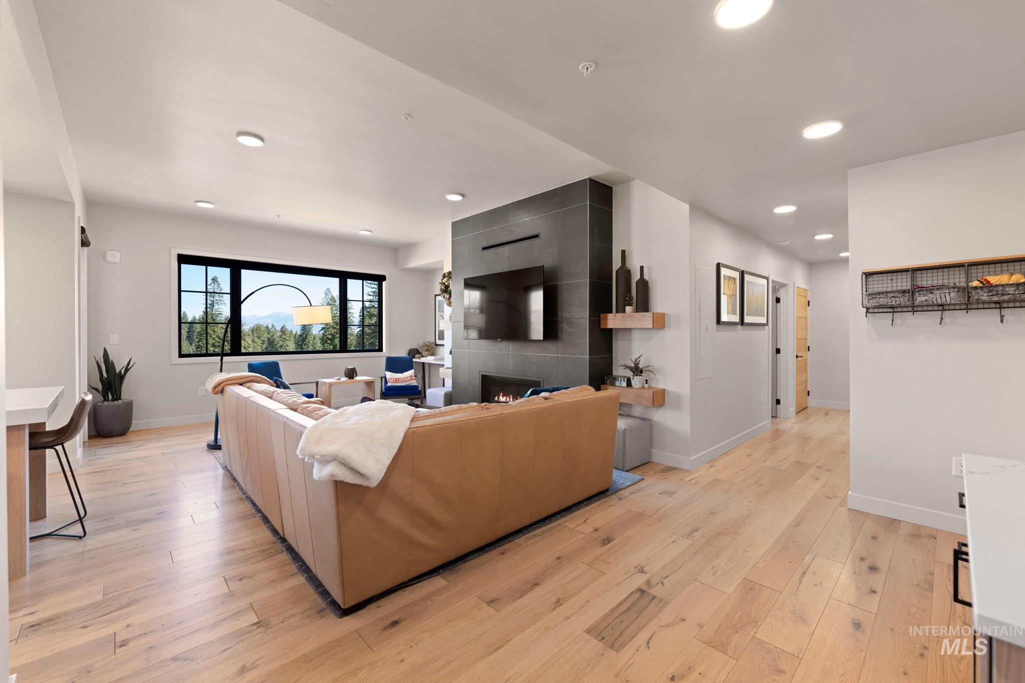 Living area featuring recessed lighting, light wood finished floors, and a fireplace