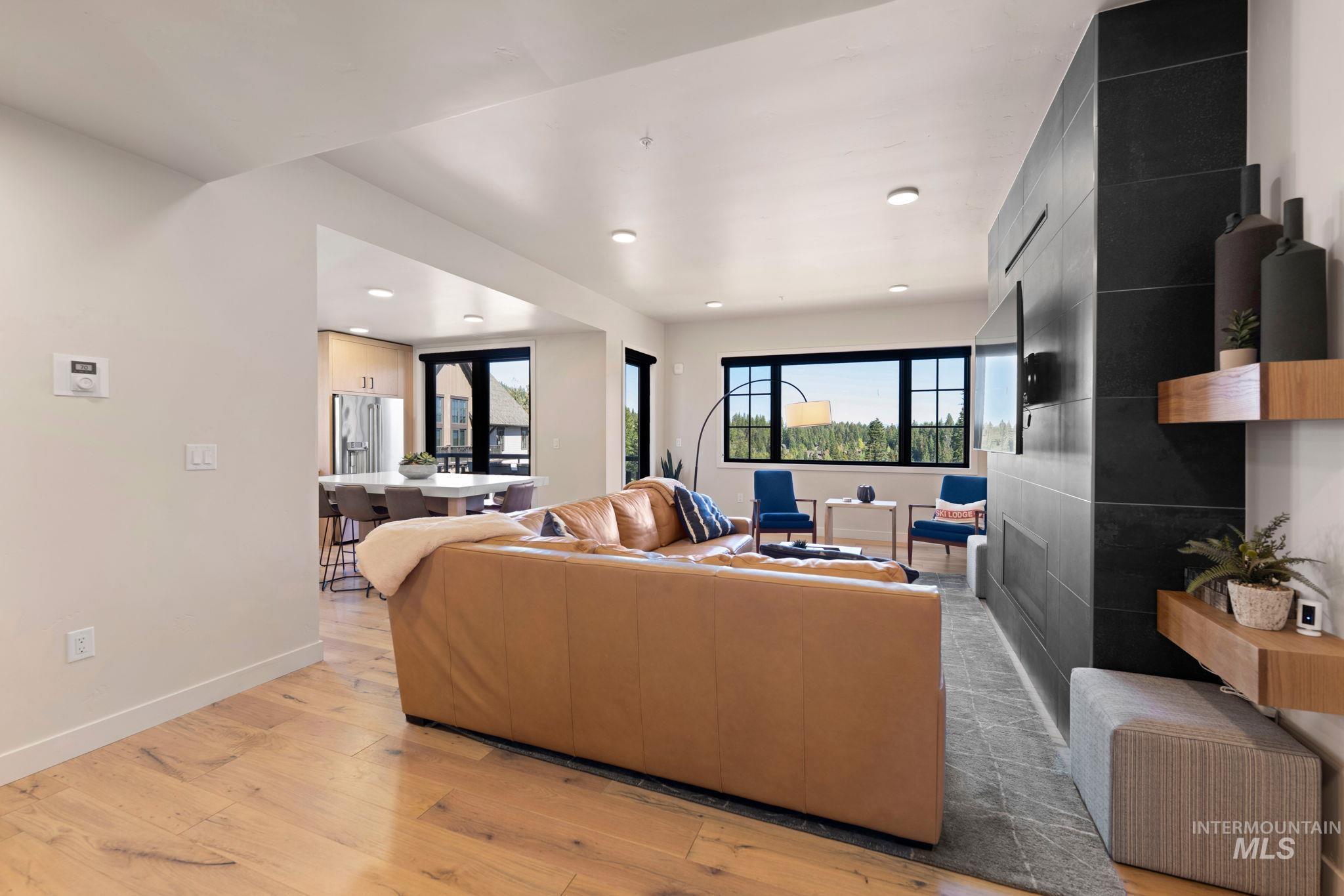 Living room with light wood-type flooring and recessed lighting