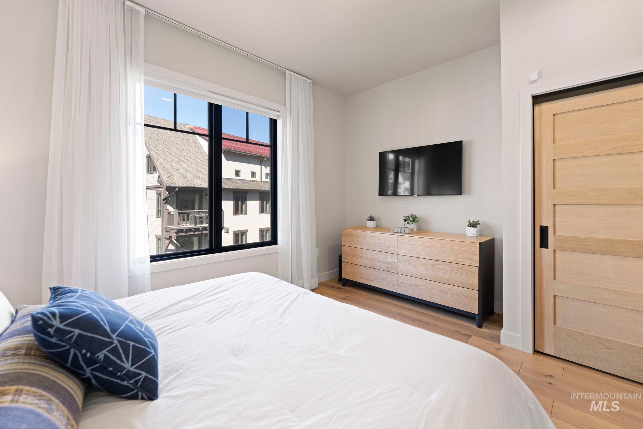 Bedroom featuring light wood-type flooring and baseboards