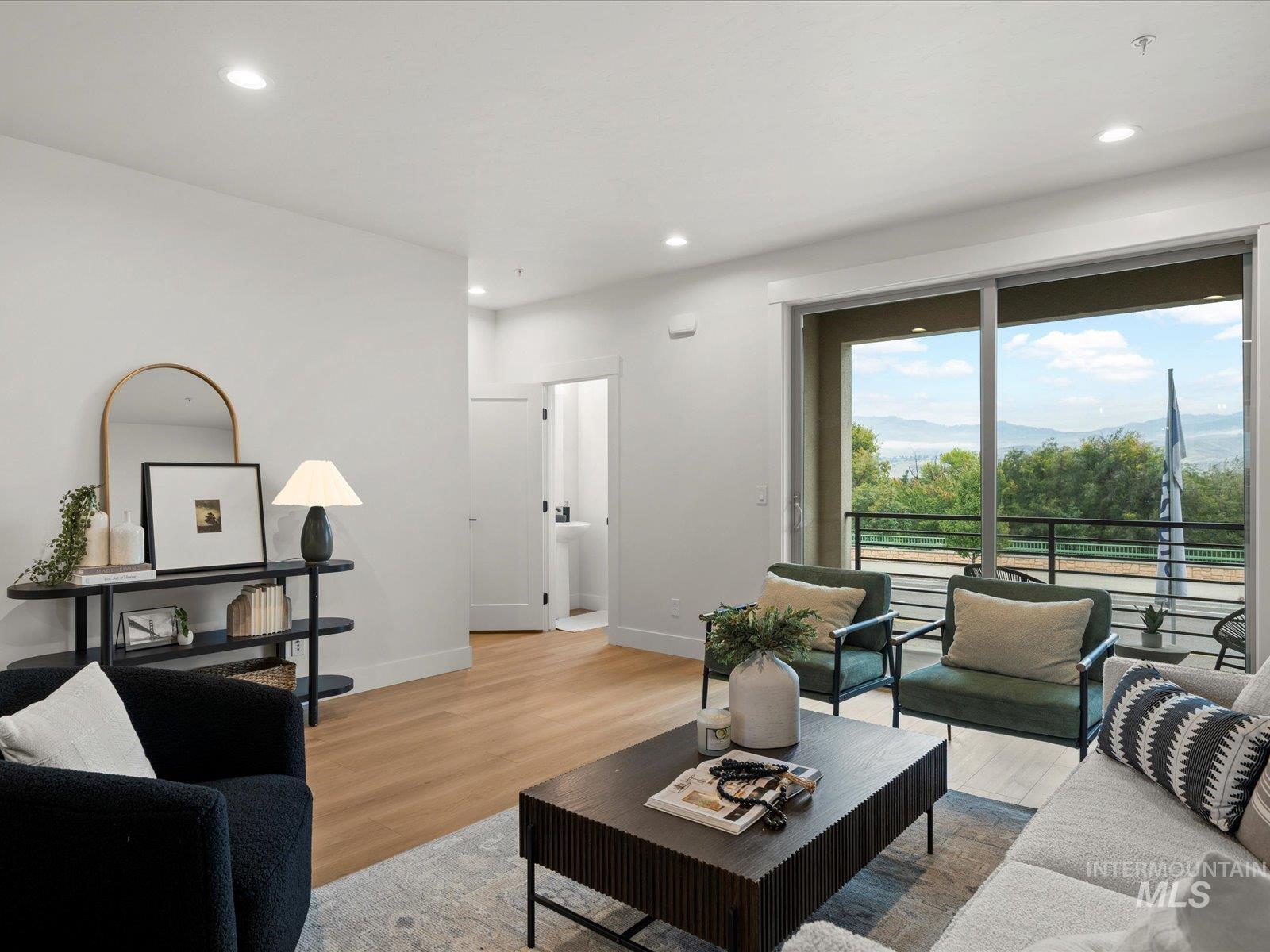 Living area featuring wood finished floors, recessed lighting, and a mountain view