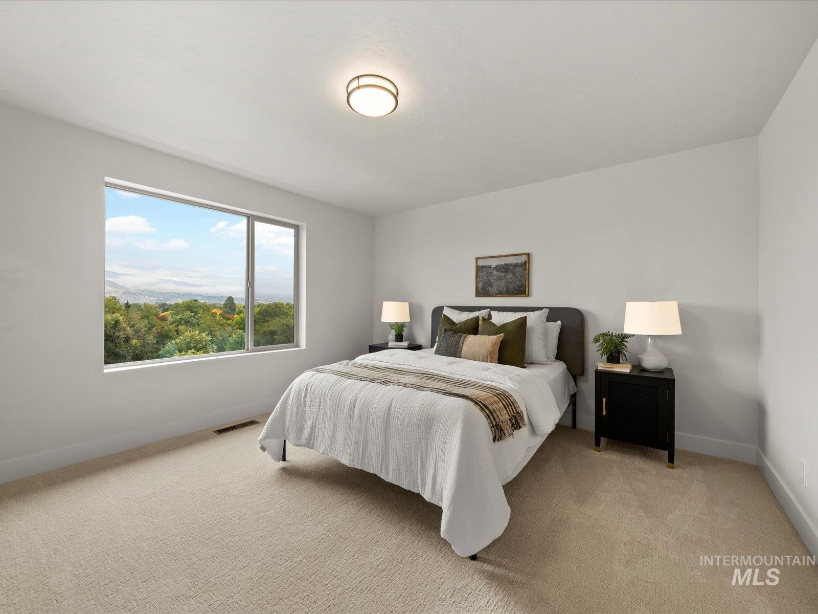 Bedroom with light colored carpet