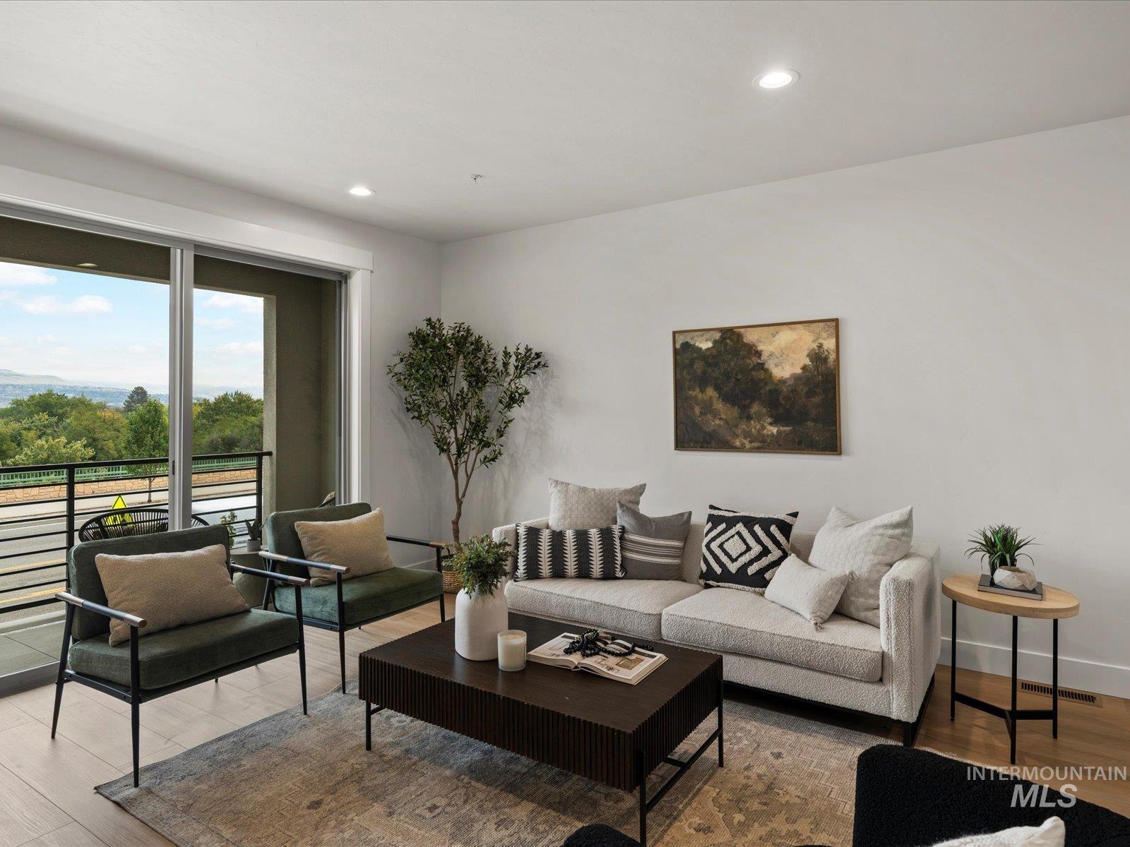 Living area with wood finished floors and recessed lighting
