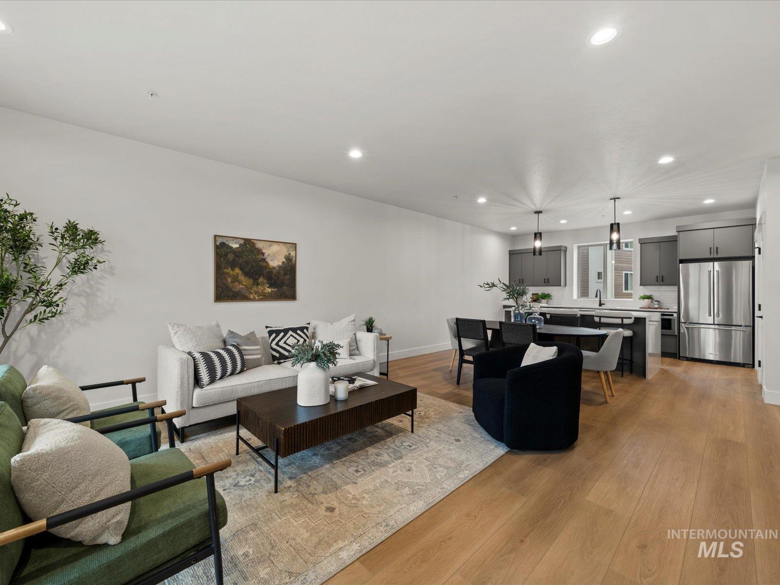 Living room with recessed lighting and light wood-style floors