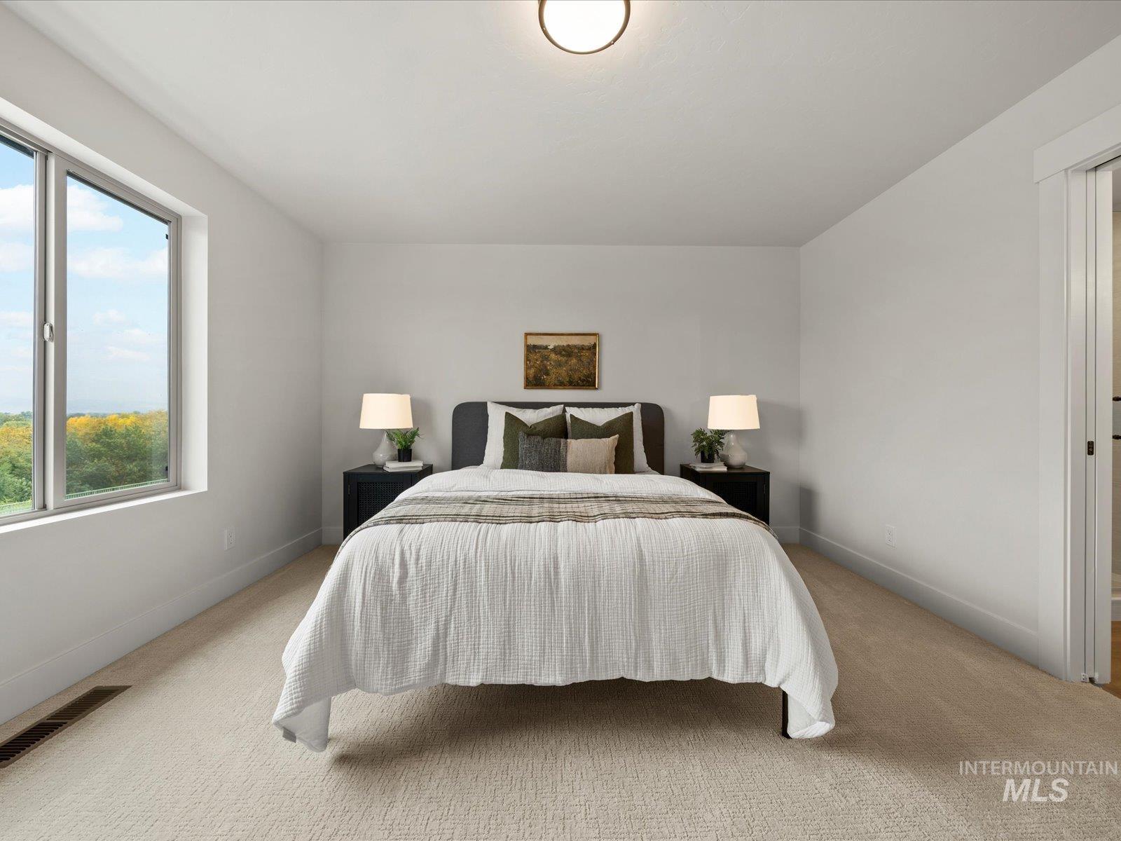 Carpeted bedroom with baseboards