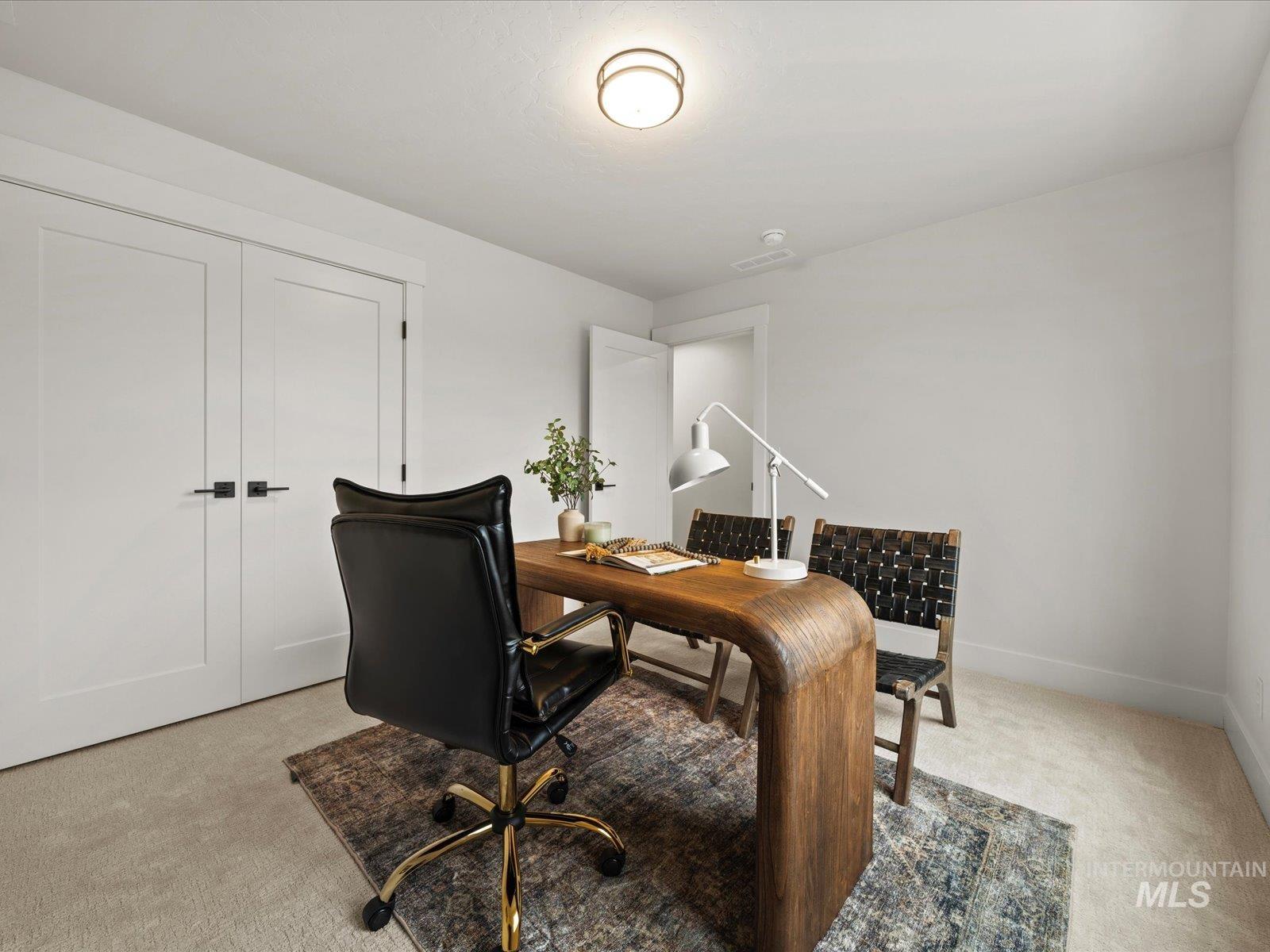 Office featuring light colored carpet and baseboards
