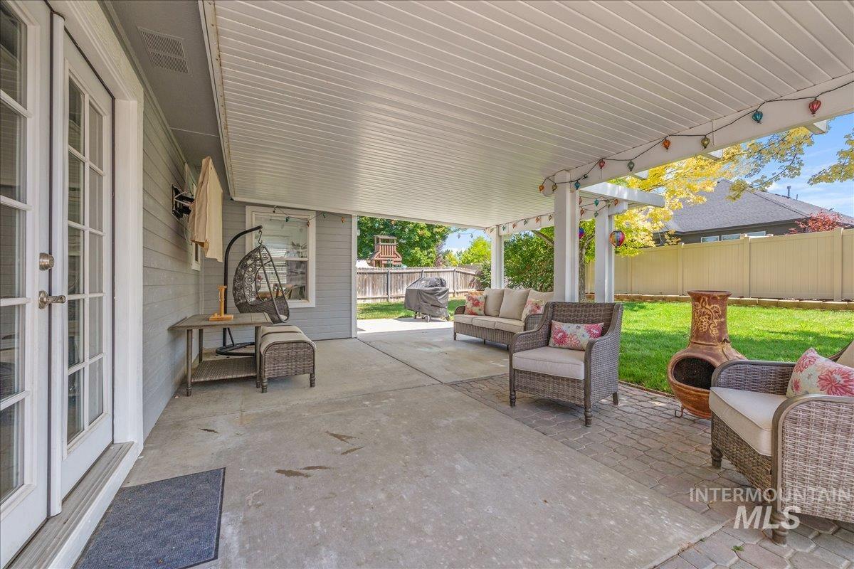 Covered patio featuring a solid ceiling and support columns