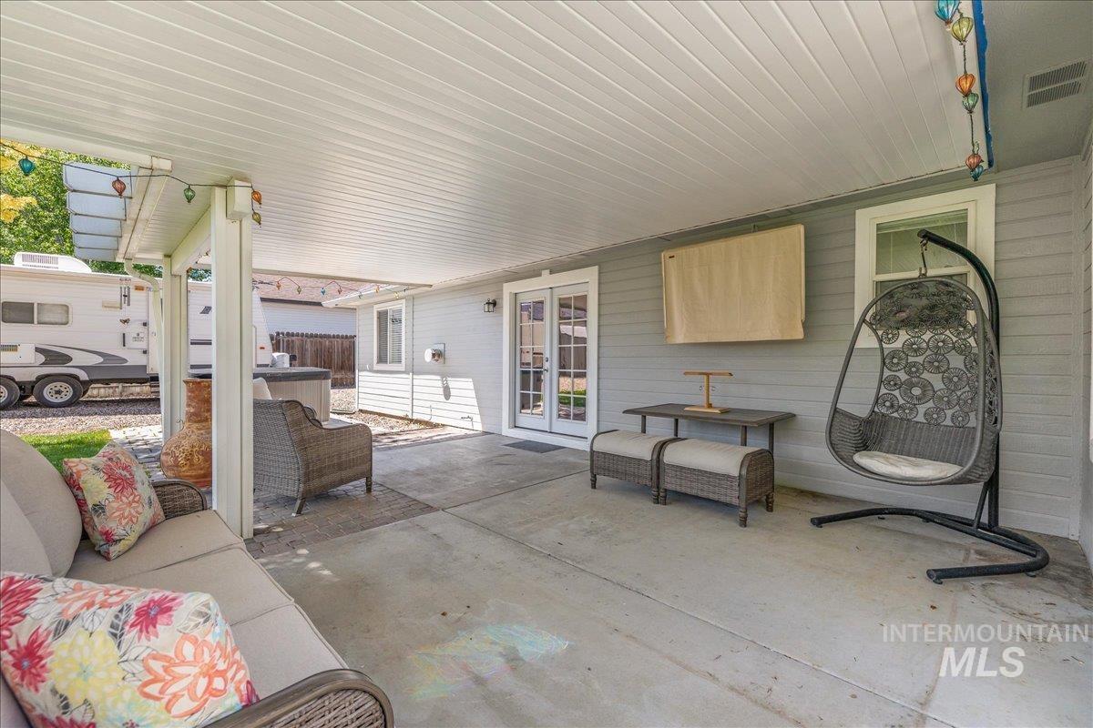 Covered concrete patio featuring recessed lighting, a ceiling fan, and direct access through double glass panel doors