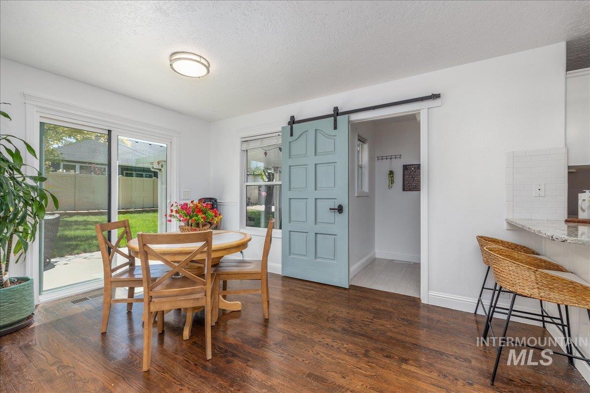 Dining area featuring wood-finish flooring and a sliding glass door to the exterior