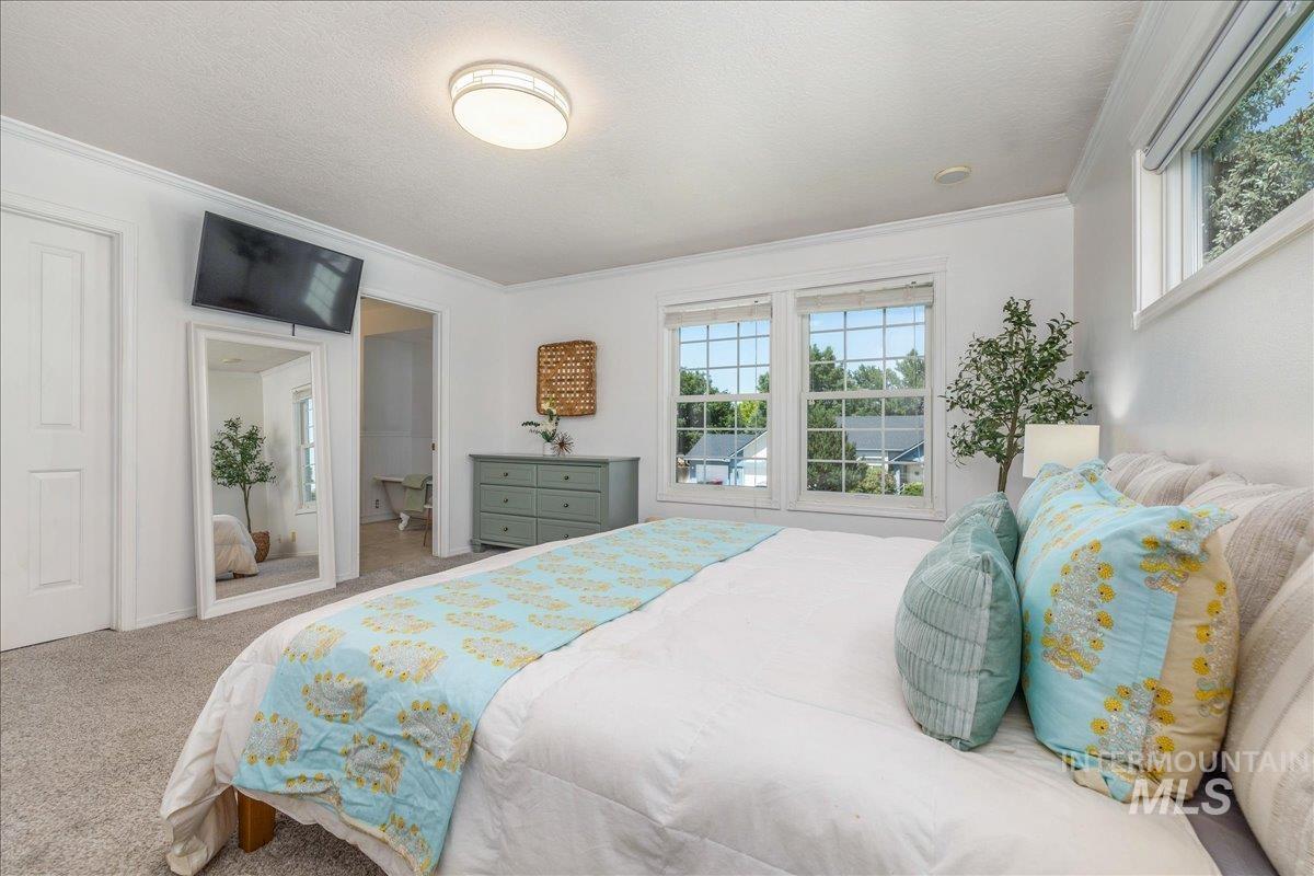 Bedroom featuring two double-hung windows and a transom window