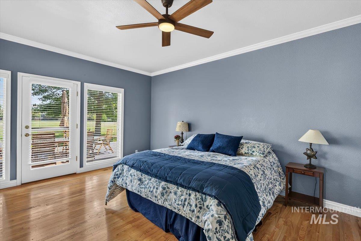 Hardwood flooring throughout featuring white baseboards