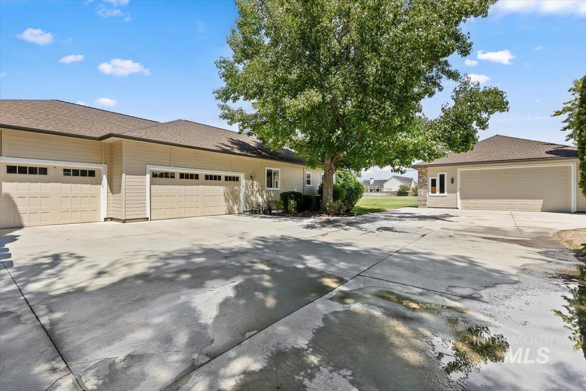 Expansive concrete driveway with multiple garage bays