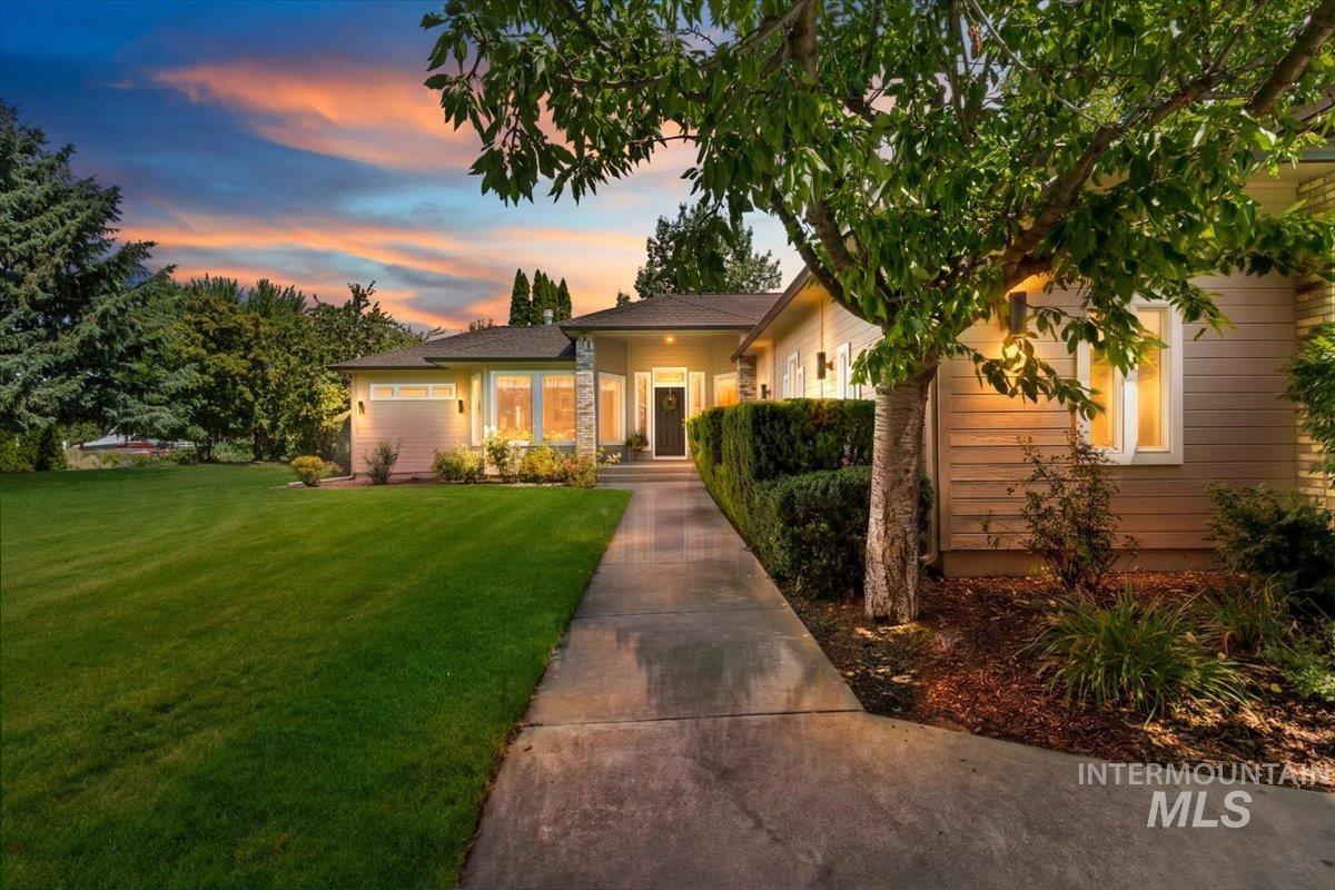 Ranch-style exterior with a dark shingle roof and light-toned siding