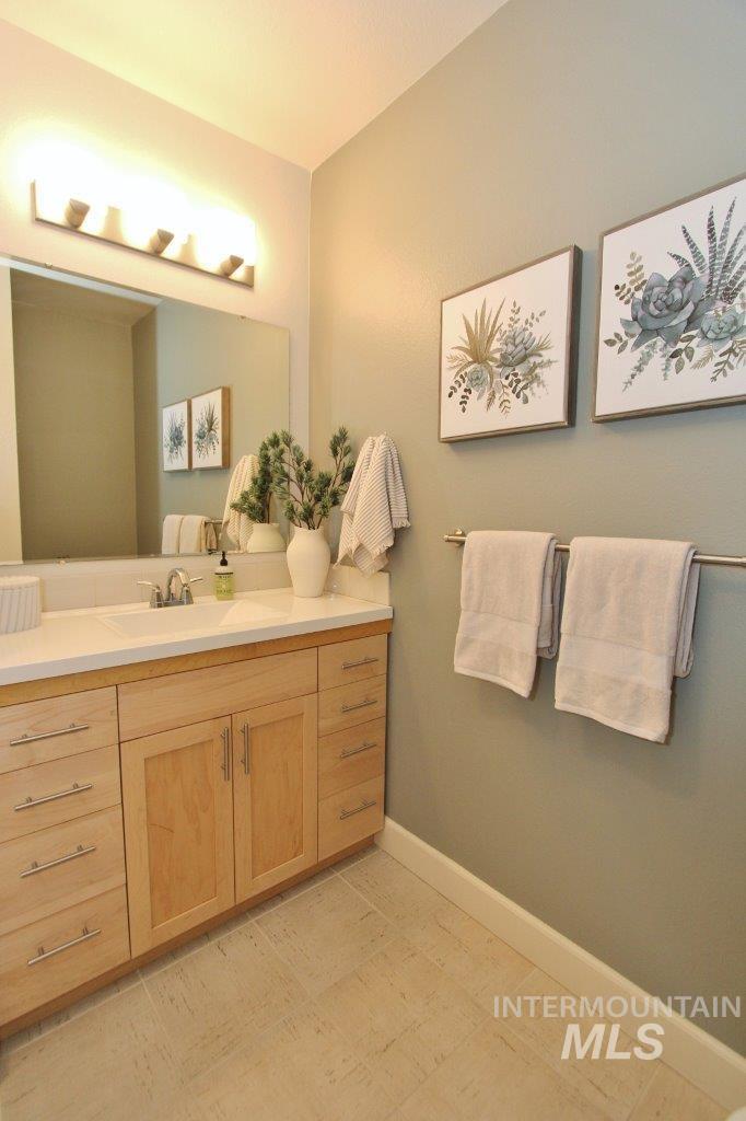 Bathroom with vanity and baseboards
