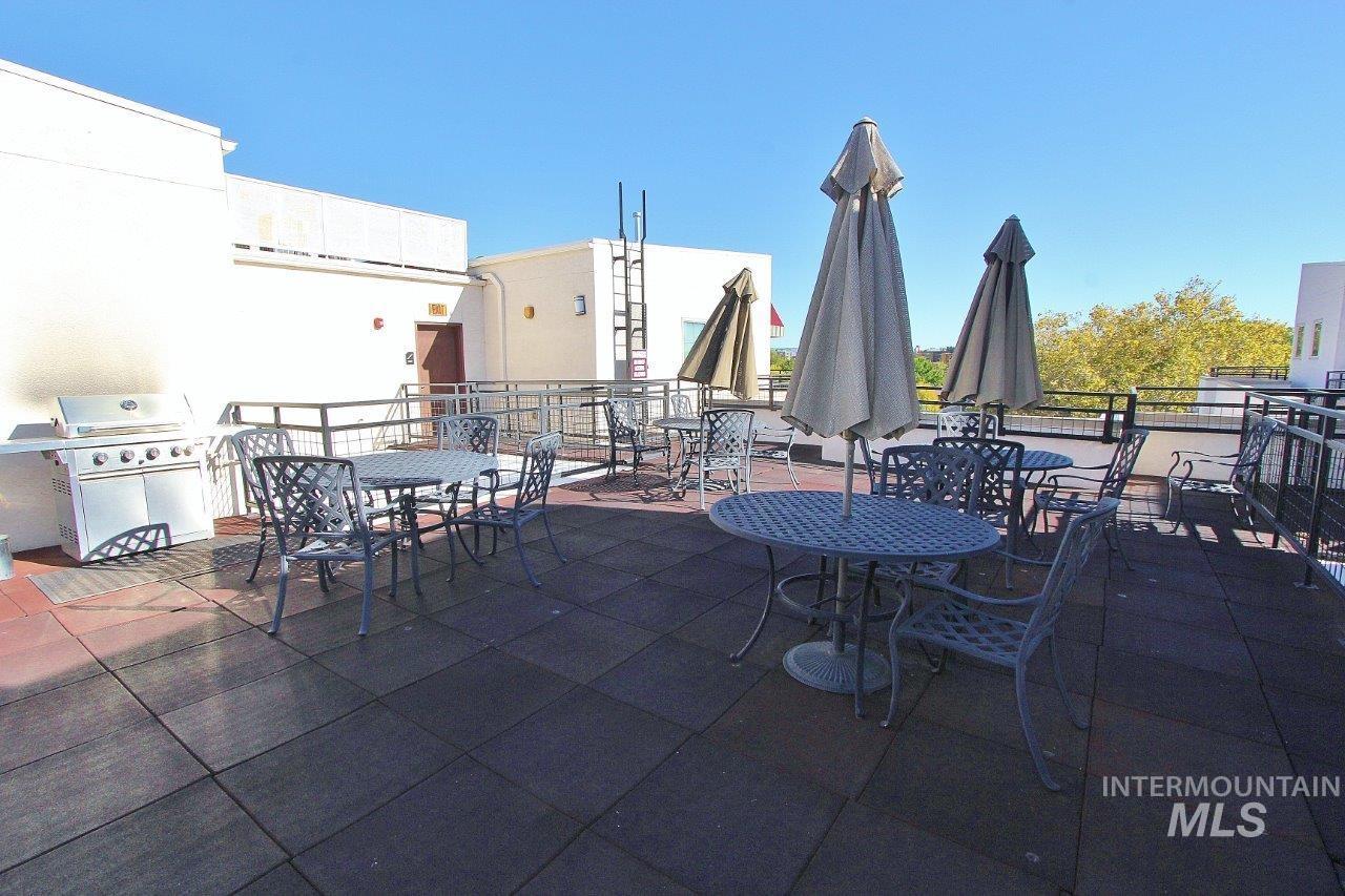 View of patio featuring outdoor dining space and a grill